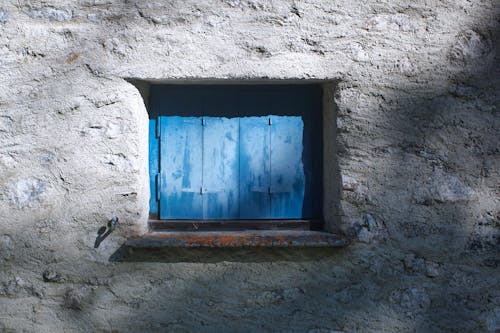 Close-up of a Window with a Blue Wooden Shutter 