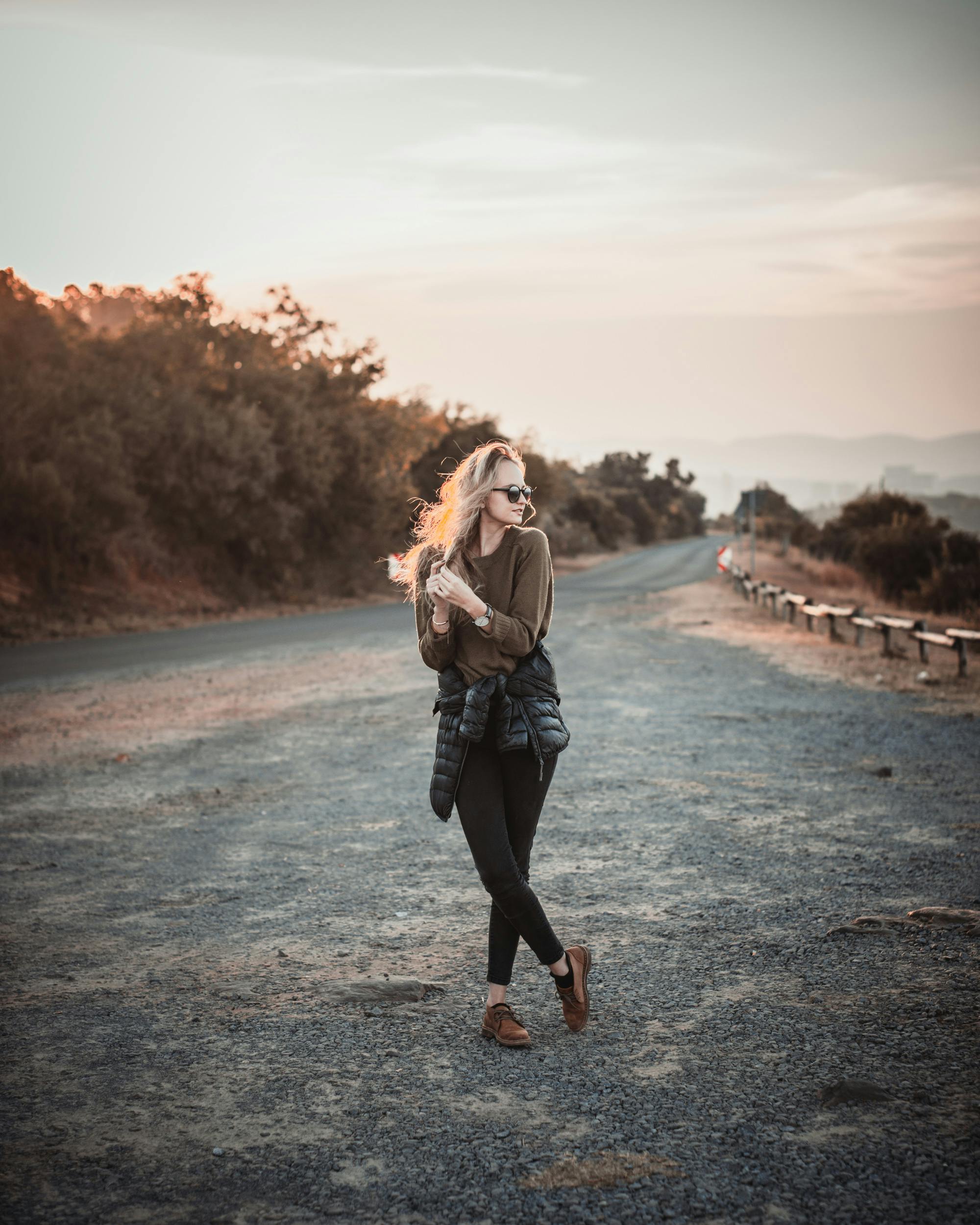 Photo of Woman Standing on Dirt Road