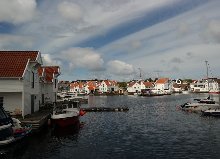 Picturesque view of Skudeneshavn's iconic waterfront with white houses and moored boats.