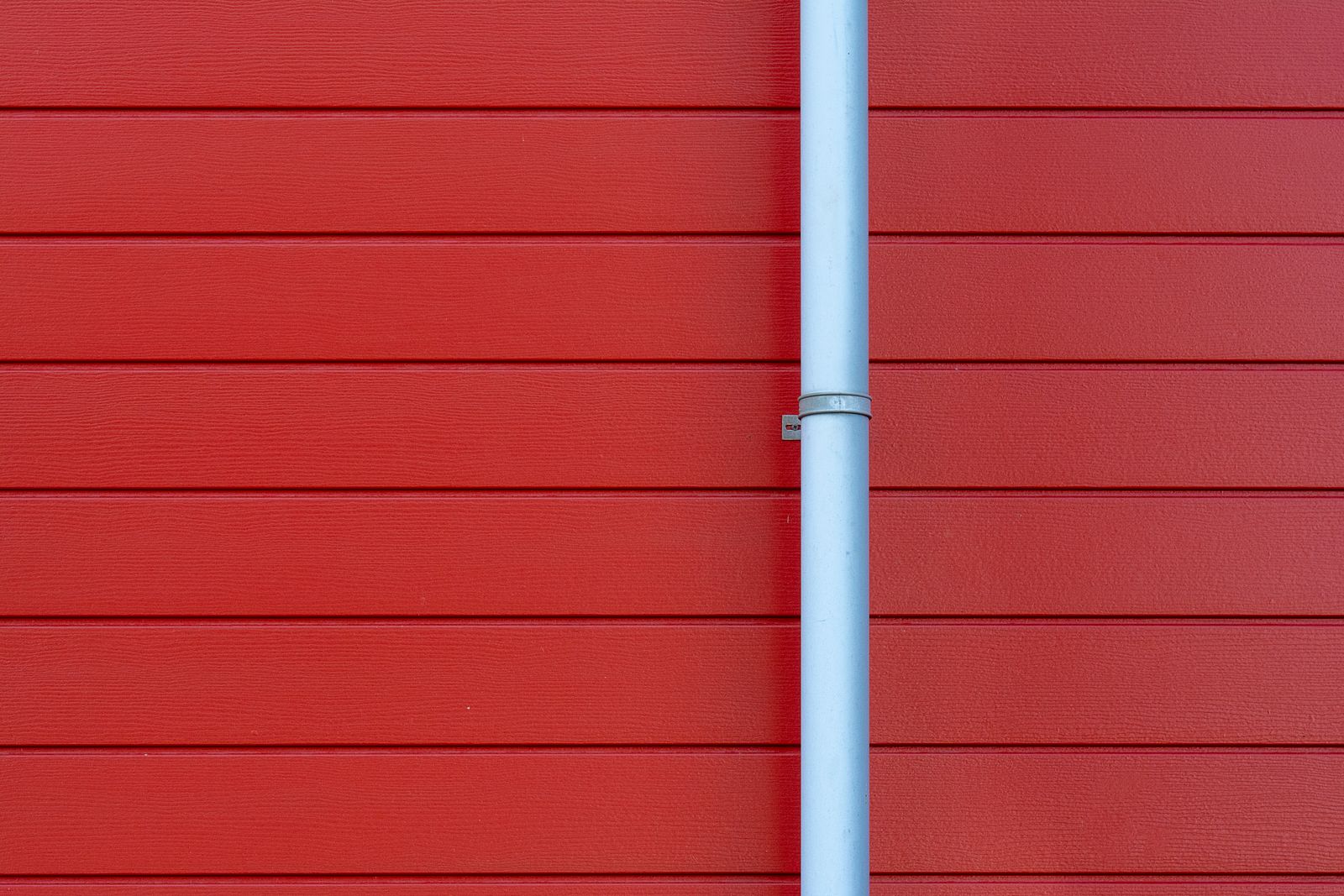 White downspout on red house siding — Core Web Vitals for Med Spa Websites Key Biscayne Explained