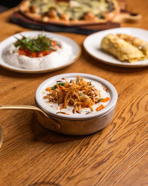 Free A variety of gourmet dishes artfully presented on a wooden table for food enthusiasts. Stock Photo