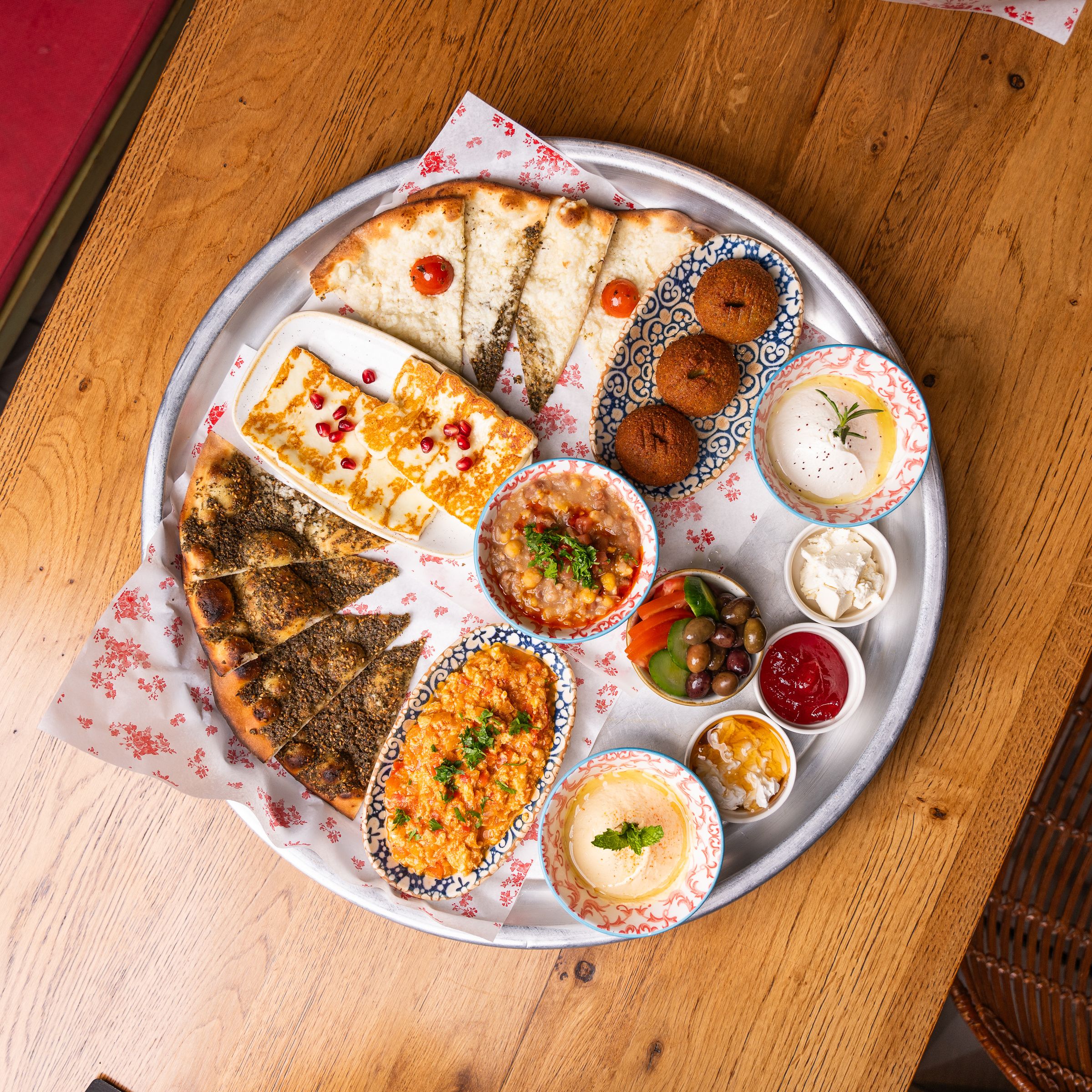 Colorful Middle Eastern mezze spread with hummus, falafel and flatbreads