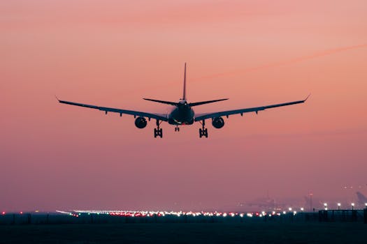 Airplane taking off at Schiphol Airport with a vibrant pink sunset sky. Perfect for travel themes.