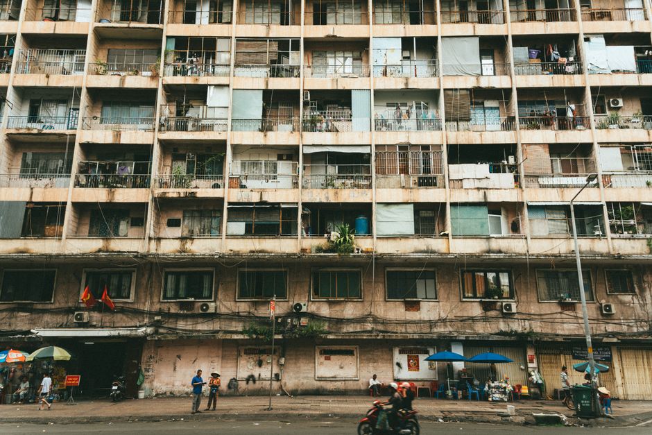 Old apartment building with balconies in Ho Chi Minh City, capturing urban residential life.