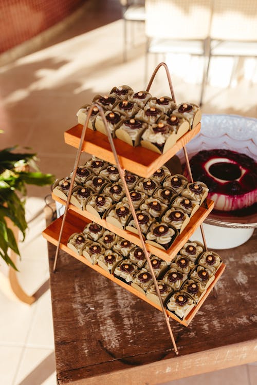 A wooden stand with three tiers of desserts