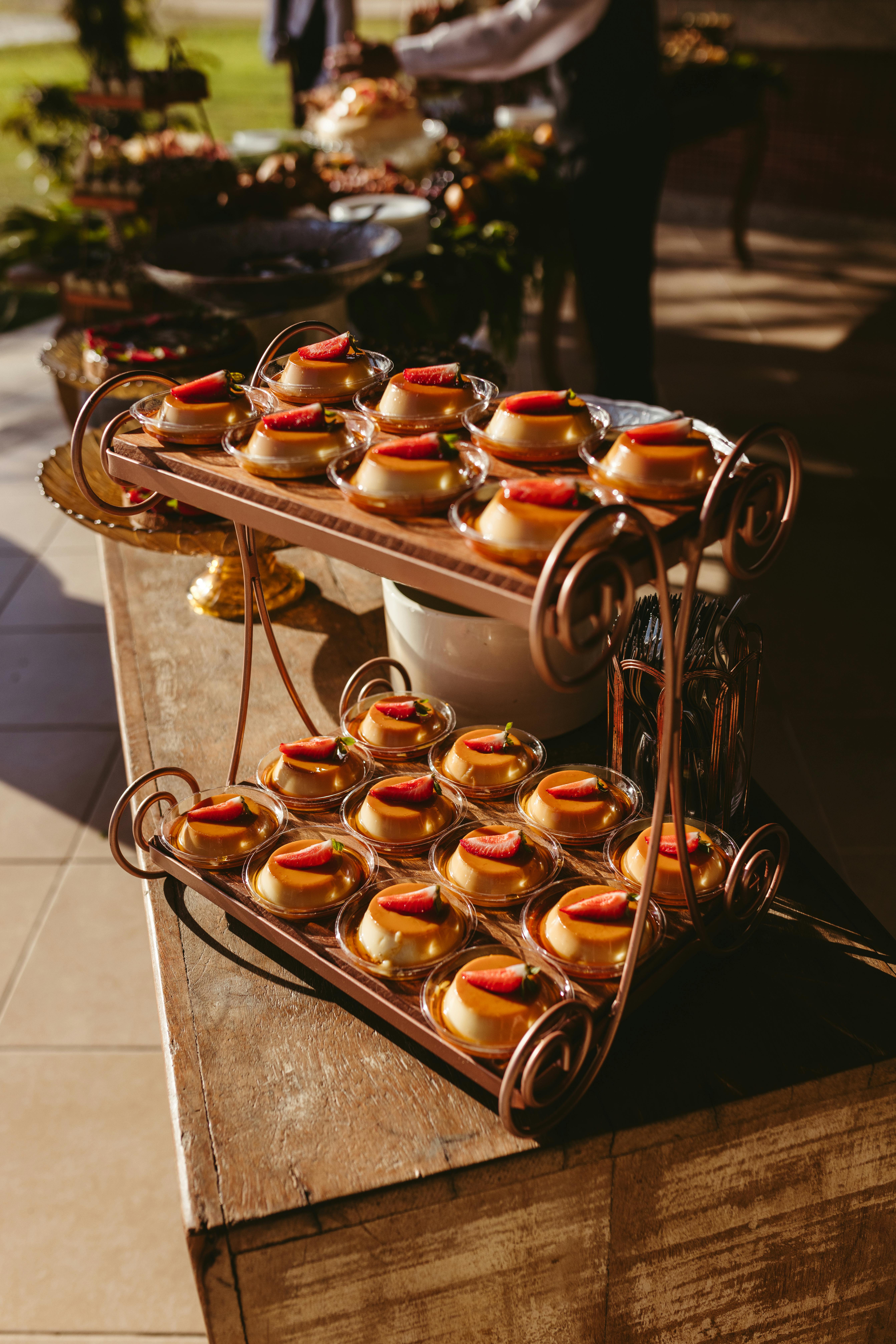 Artistic display of strawberry cheesecakes on a rustic tray at an outdoor event, perfect for food photography enthusiasts.
