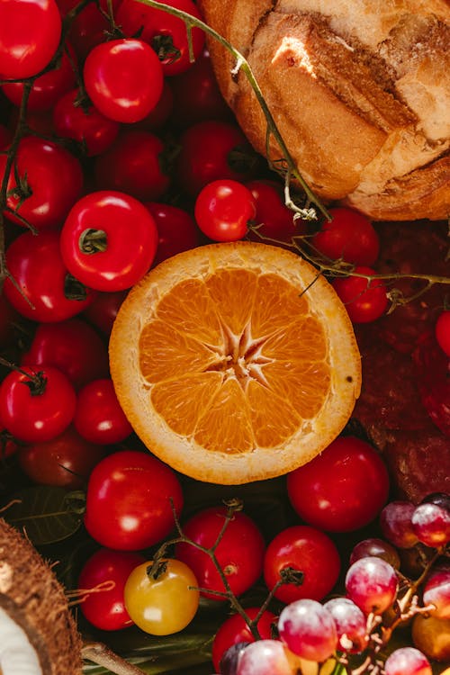 A close up of fruit and vegetables with an orange