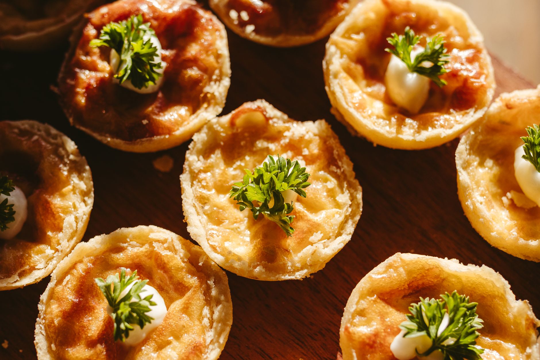 Close-up of baked mini cocotte meals garnished with fresh herbs