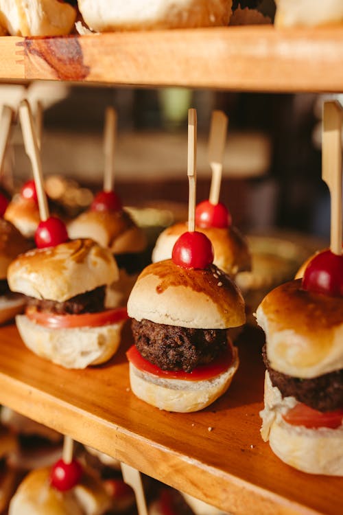 Mini burgers with cherry tomatoes on sticks