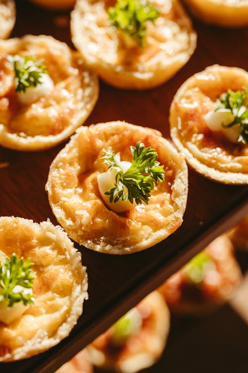 Small appetizers are on a tray with parsley