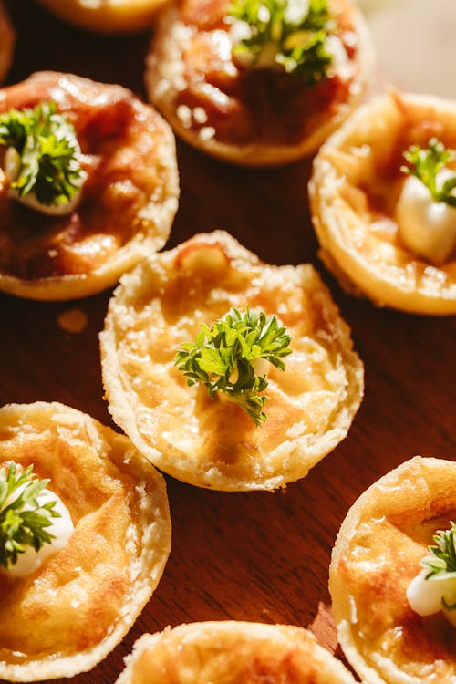 Small pies with herbs on top of a wooden board