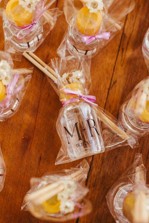 Free Elegant aroma gift bottles wrapped in cellophane with flowers and sticks for a special occasion. Stock Photo