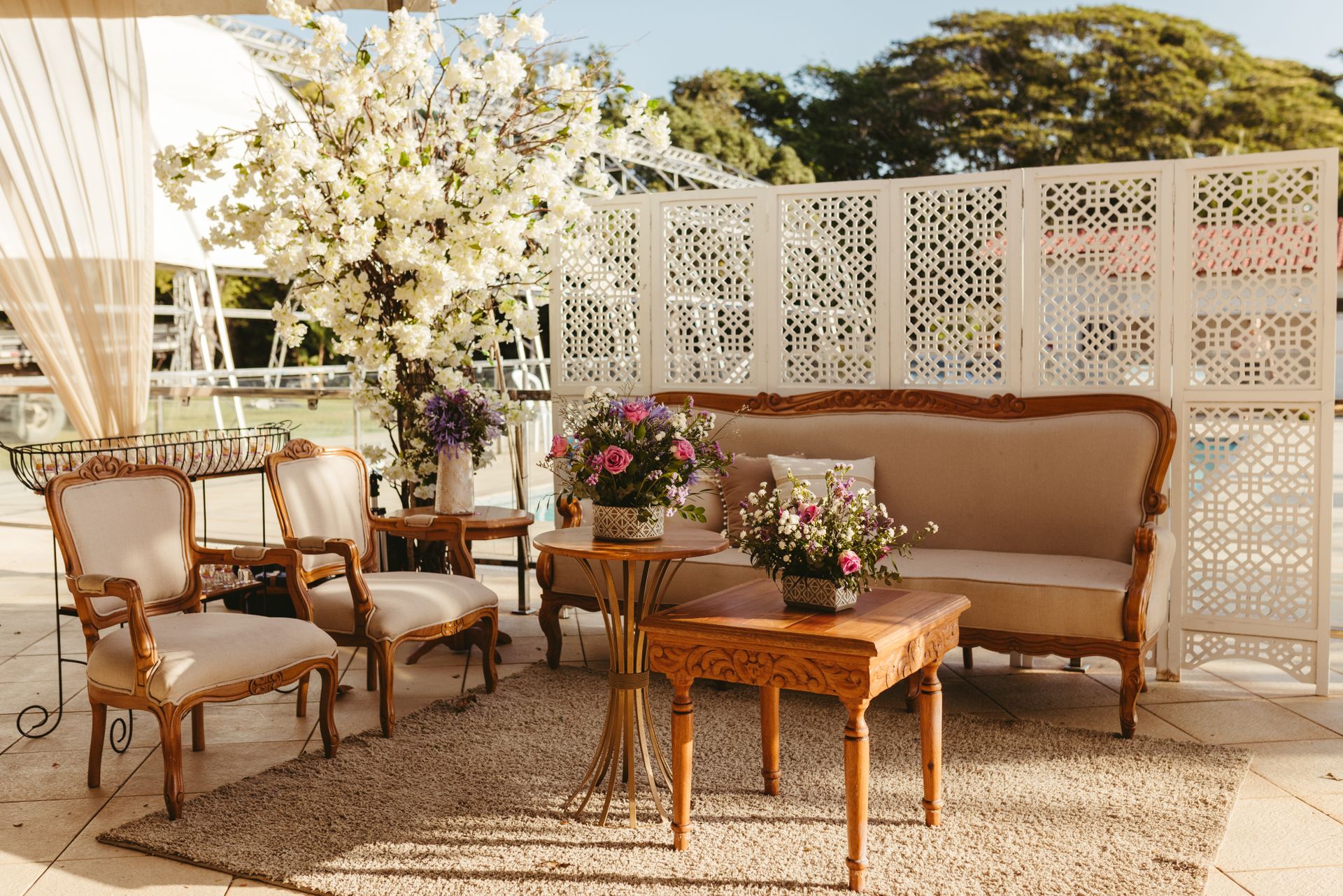 Charming outdoor patio with vintage furniture and floral decor, perfect for relaxation.