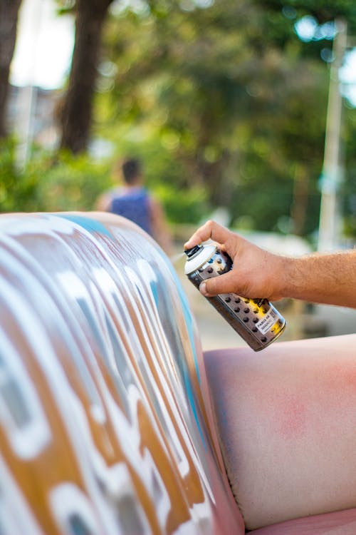 Person Spray painting on Wall