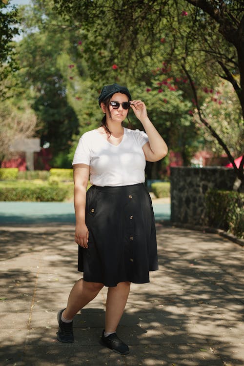 A woman in a black skirt and white shirt