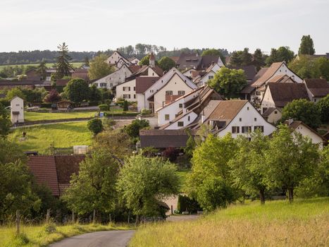 Scenic view of a picturesque village surrounded by greenery in spring.