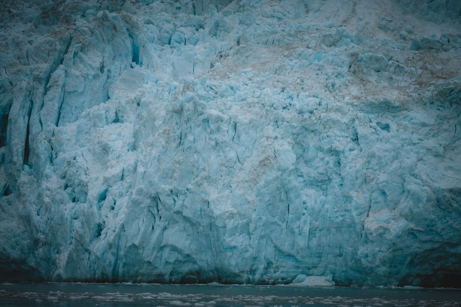 Alaska Helicopter Tour with Glacier Landing - 60 mins - ANCHORAGE AREA - A dramatic close-up of a majestic arctic glacier with icy blue textures in nature.