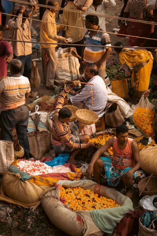 Free A busy Indian market scene showcasing vibrant flower stalls and traditional shopping activities. Stock Photo