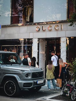 Shoppers outside Gucci store in Frankfurt am Main, showcasing urban luxury and sophisticated style.