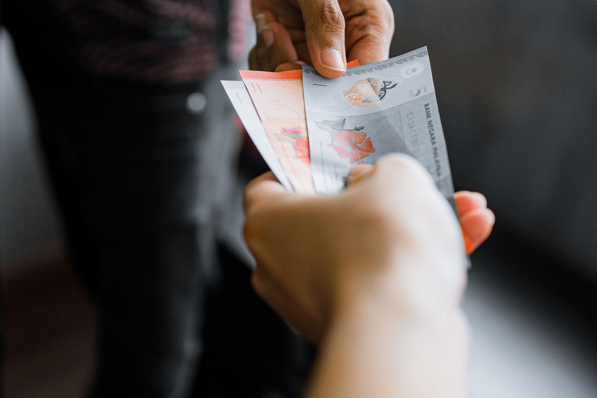 Cash being handed over at a counter