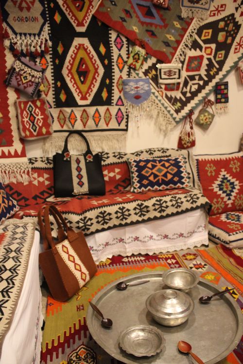 Free Cozy interior filled with traditional handwoven textiles, bowls, and decorative items. Stock Photo