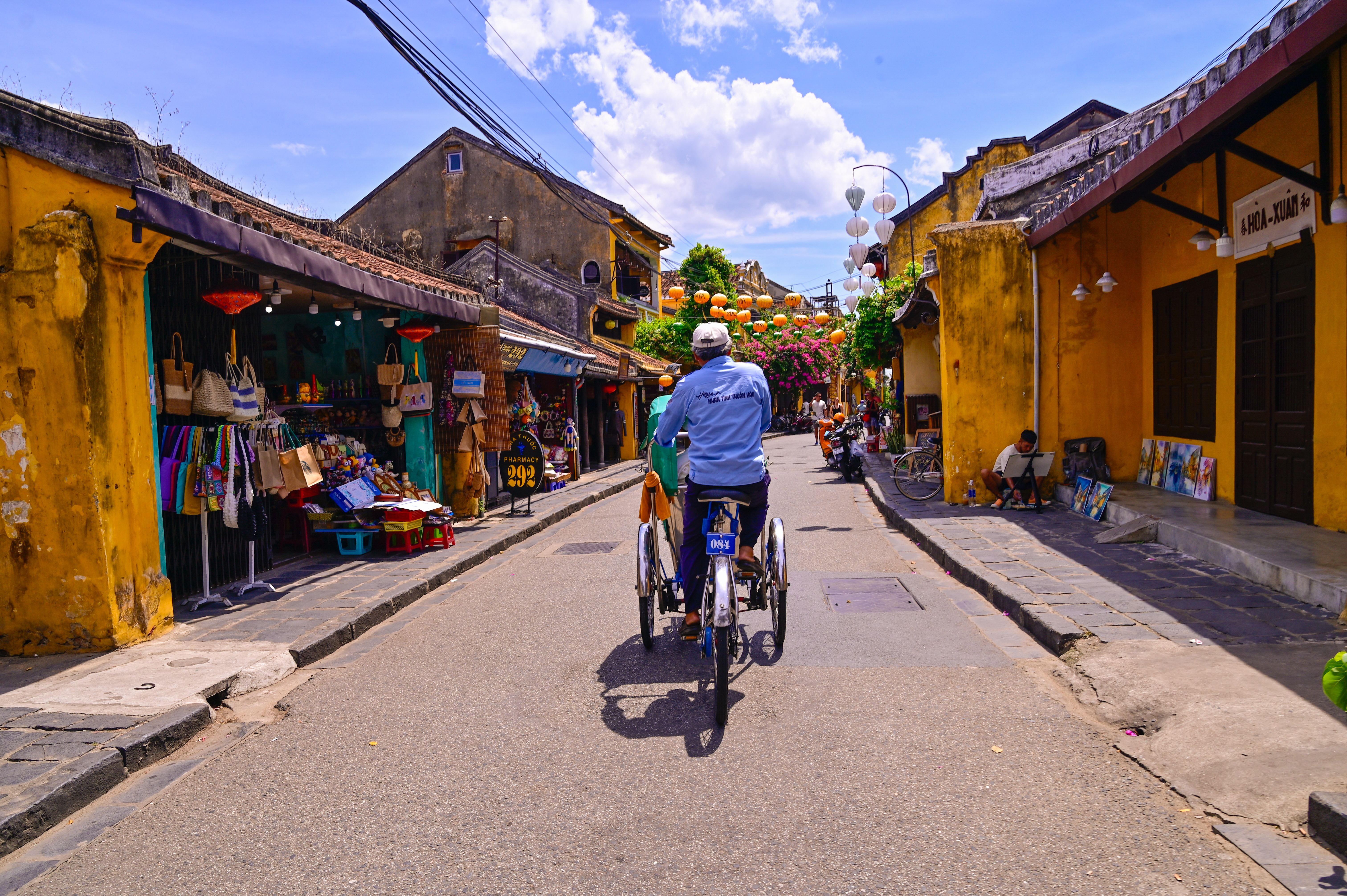 Back View of a Man Riding a Tricycle through a Market Street · Free ...