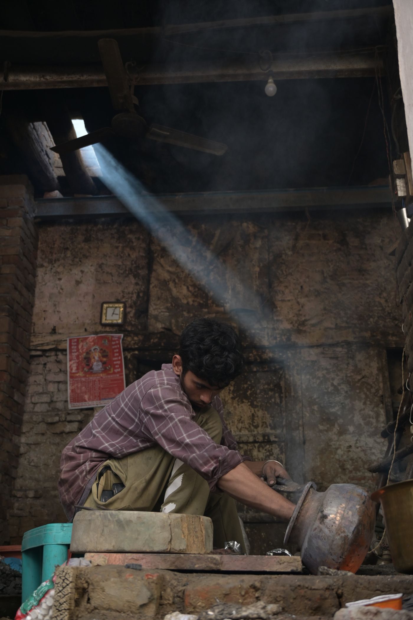 An artisan working in a rustic Indian workshop, symbolizing hands-on skill development.