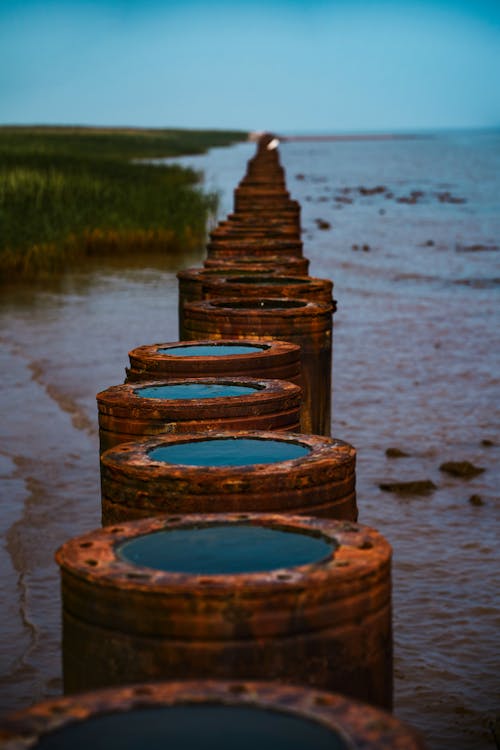 A row of wooden posts with water in them