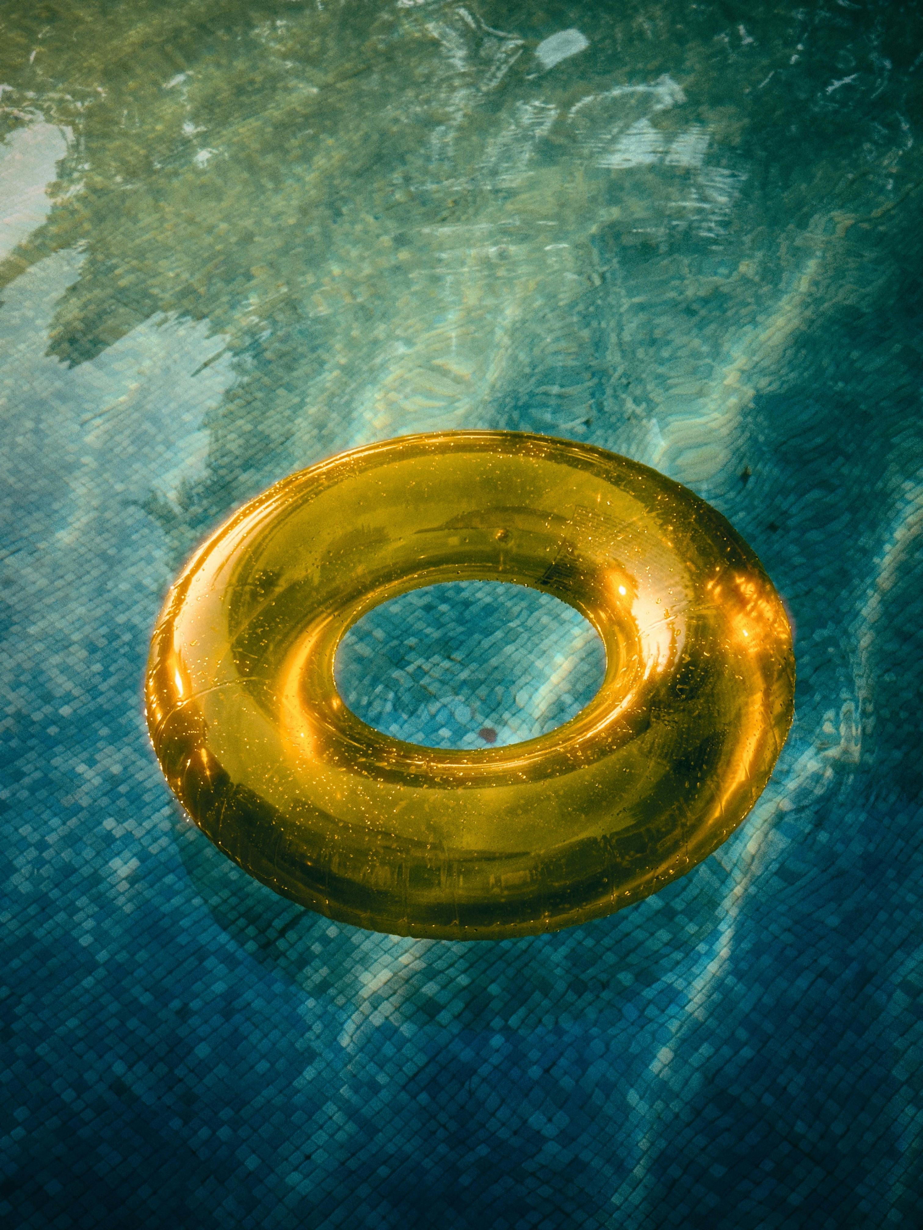 yellow swim ring on water in pool