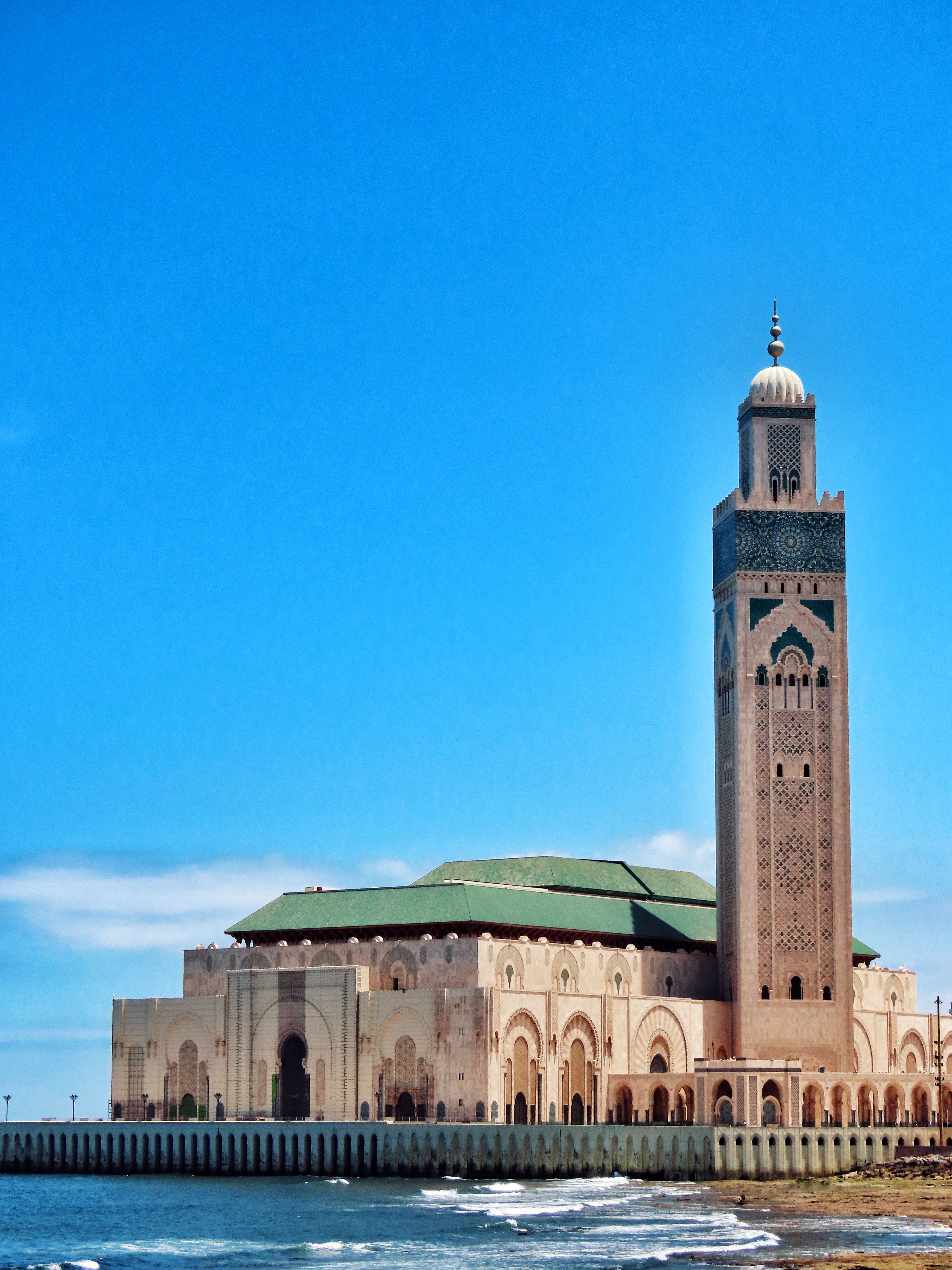 Stunning view of Hassan II Mosque's minaret against the ocean in Casablanca, Morocco.