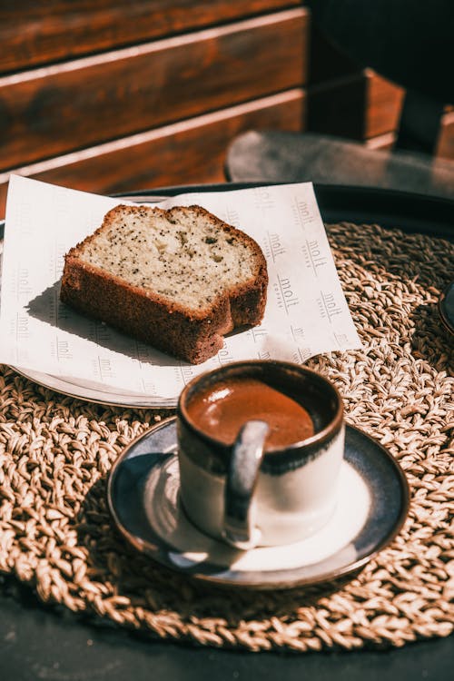A slice of bread and a cup of coffee on a table