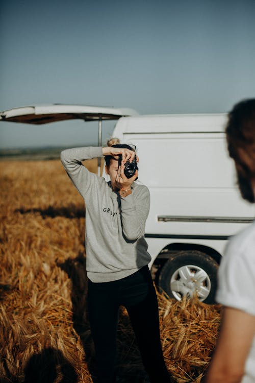 Photo of a Woman Taking Photo of Man