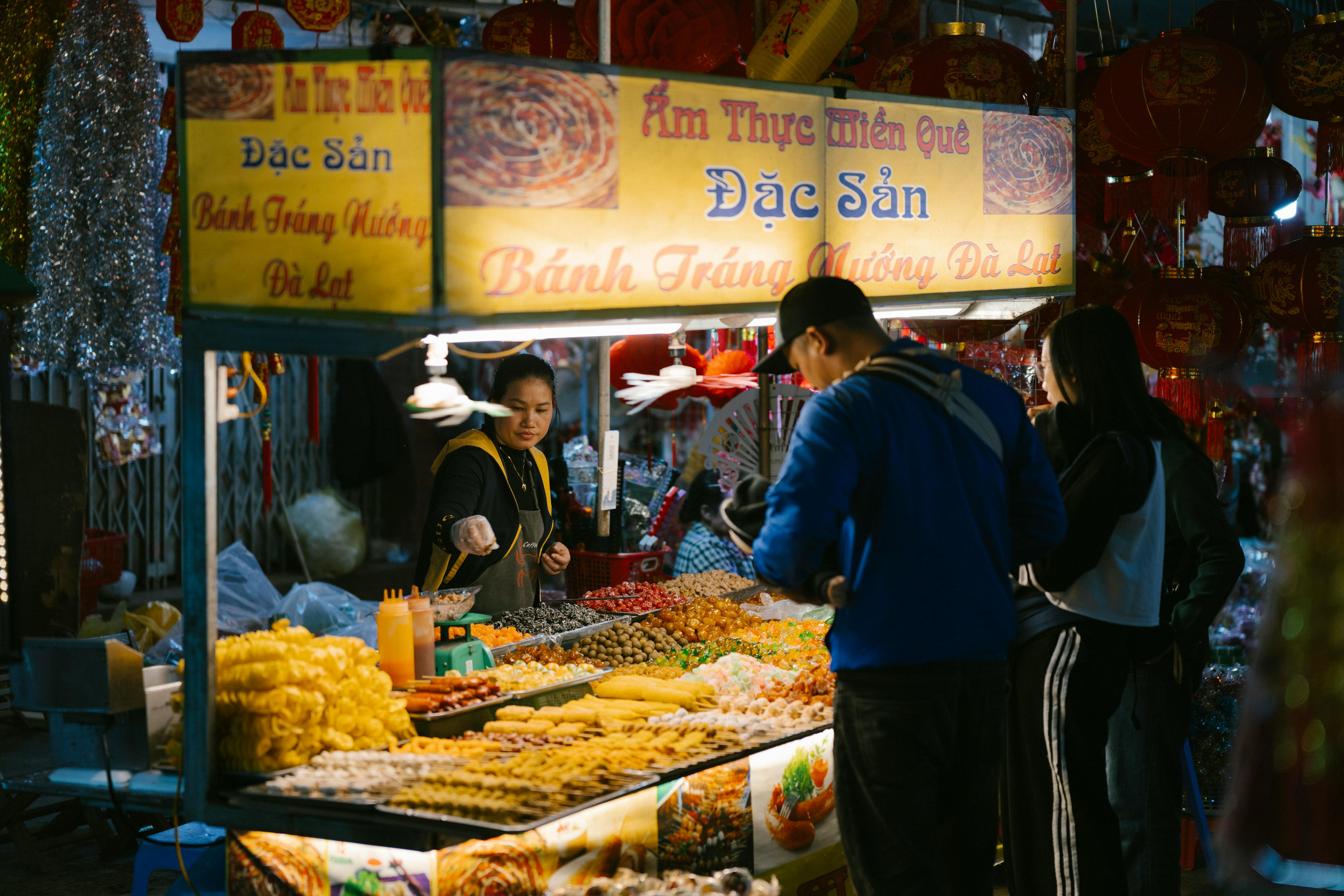 people buying food at the market in vietnam