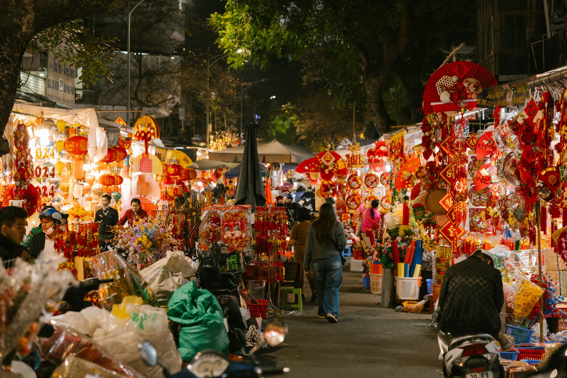 A bustling night market filled with colorful lanterns and festive decorations.