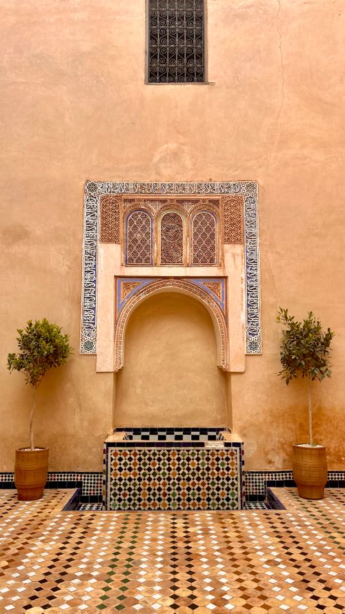 Free Beautifully detailed Moroccan facade with intricate tiles and potted plants in Marrakesh, Morocco. Stock Photo