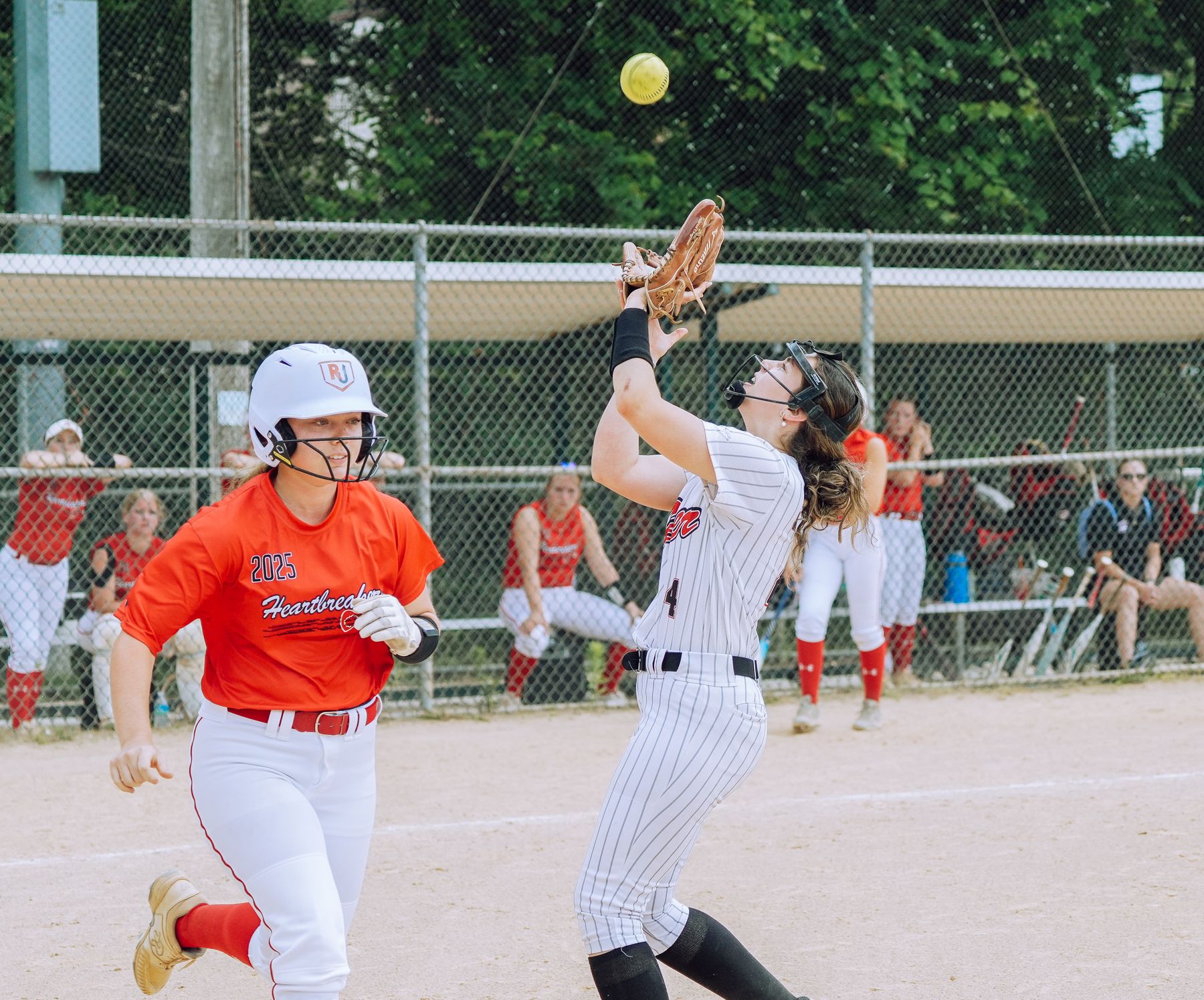 Teen softball athletes in game action