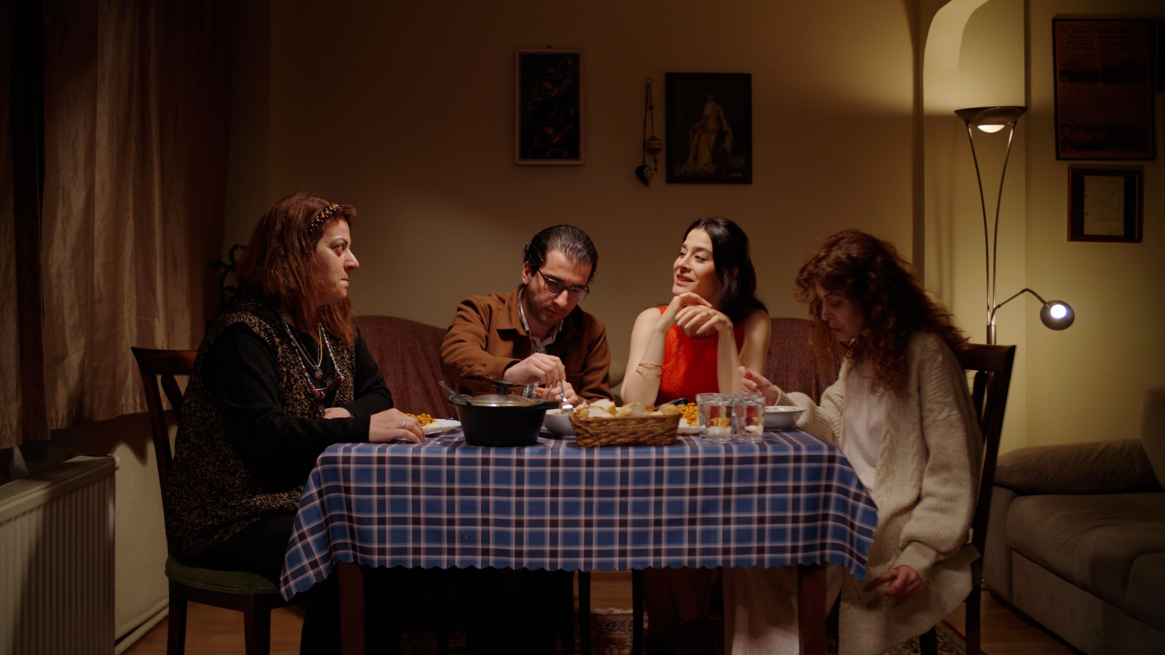 Four people share a cozy evening meal, enjoying togetherness and conversation.