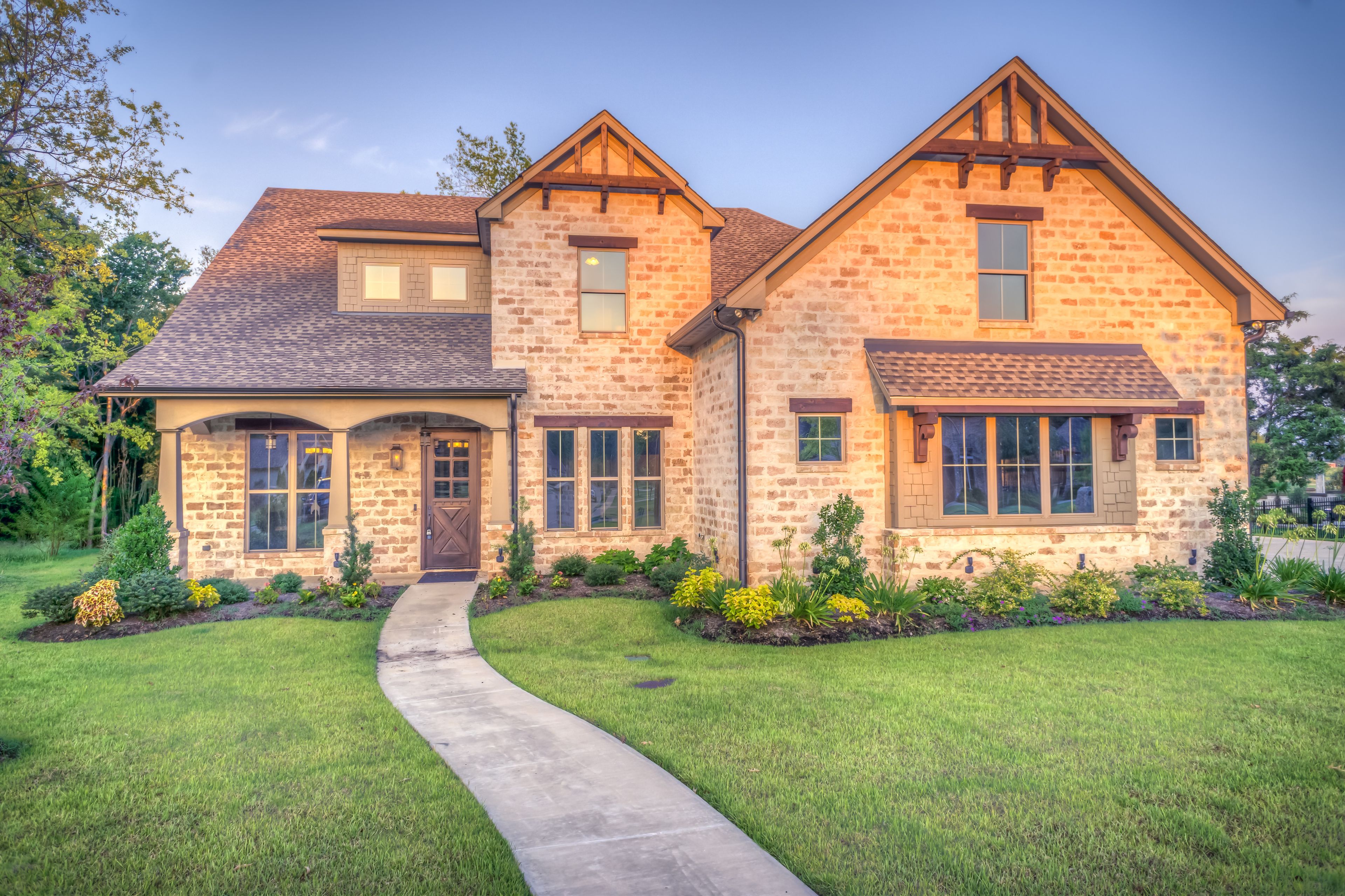Brick craftsman home glowing at golden hour