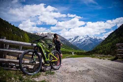 Free A young woman enjoys a scenic mountain bike ride through Livigno, Italy, on a bright summer day. Stock Photo