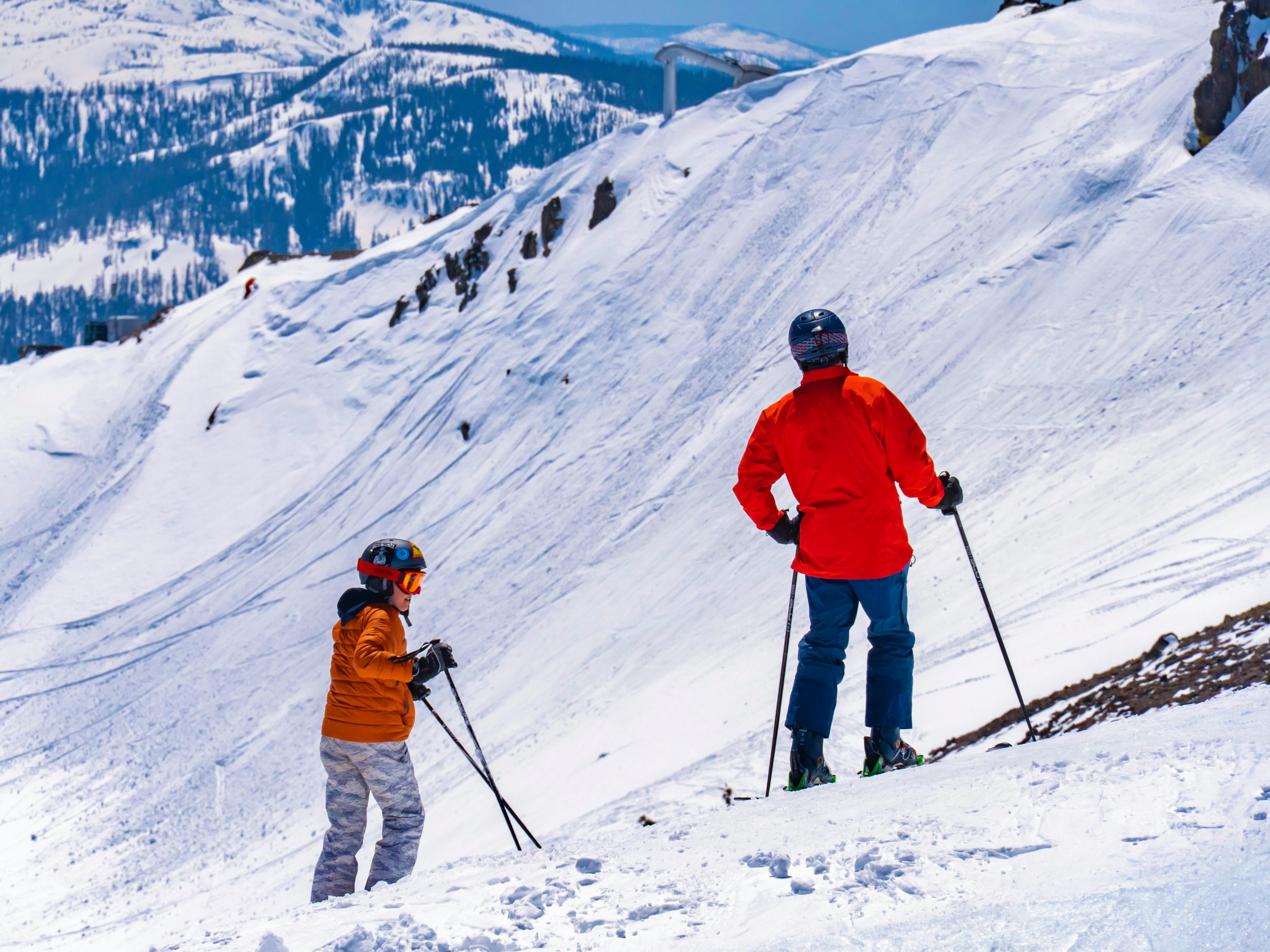 Two skiers navigating a snowy mountain slope in the United States during winter.