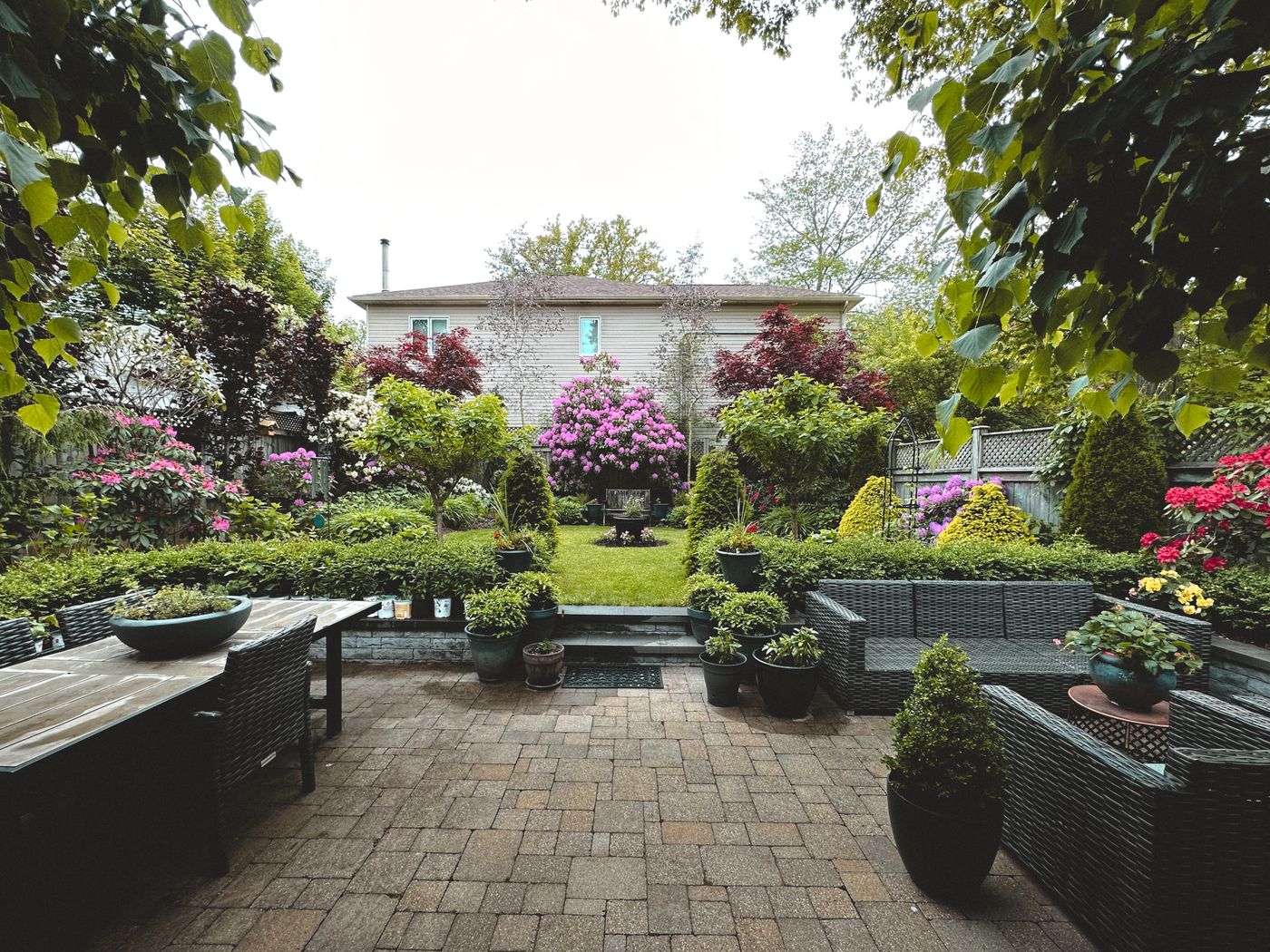 Tidy backyard garden with patio furniture and lawn