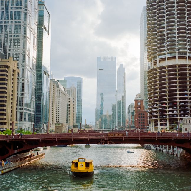 Explore the vibrant Chicago cityscape featuring skyscrapers and river bridge.
