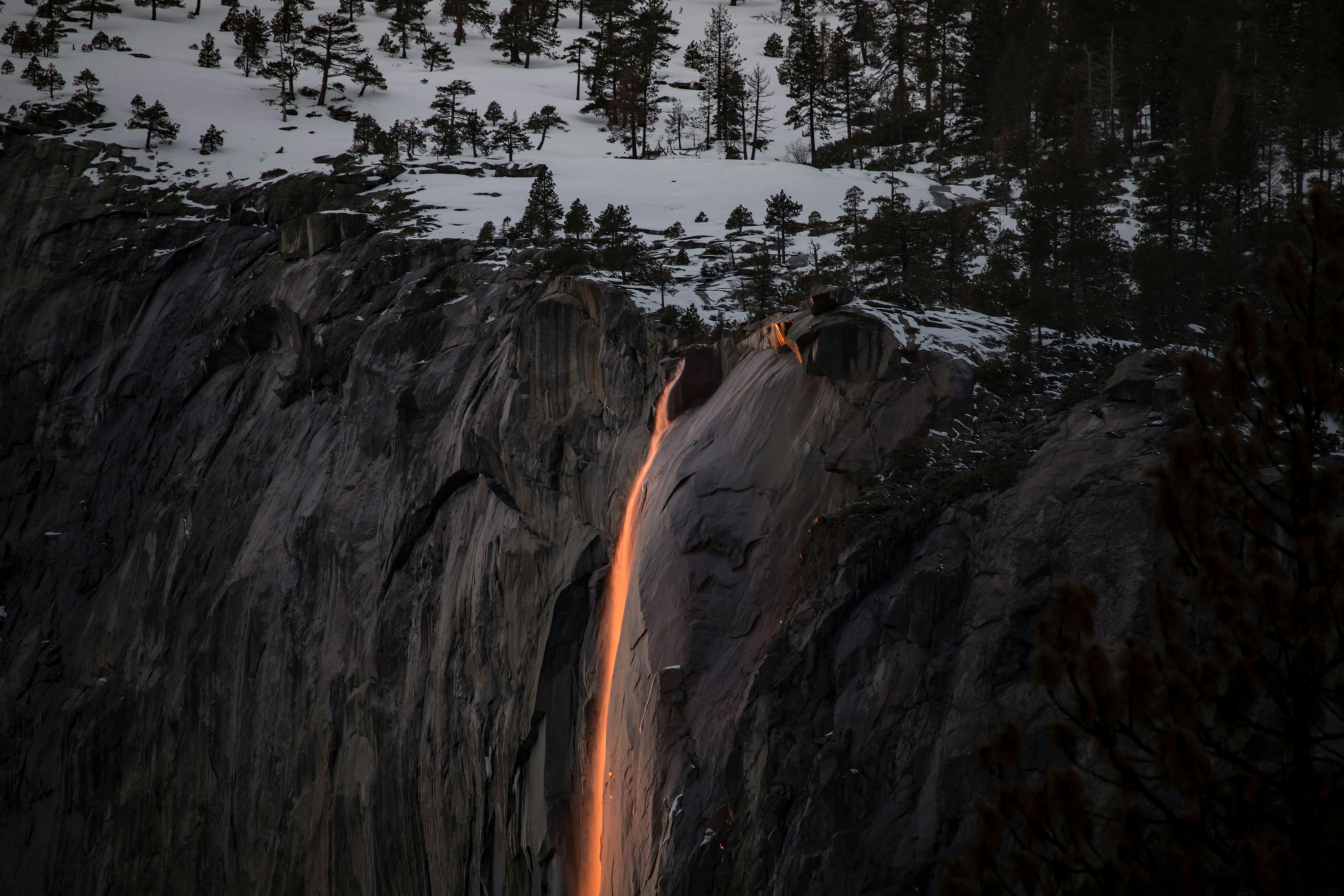 Majestic view of Horsetail Fall glowing in sunset light at Yosemite National Park.