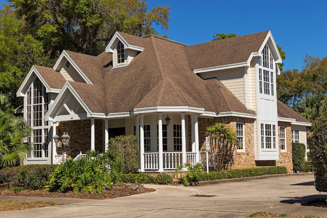 Brown roofing White House Beside Trees 