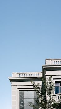 Contemporary building facade against a clear blue sky in Curitiba, Brazil.