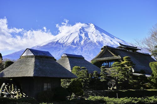 Gray Huts Near Snow-capped Mountain