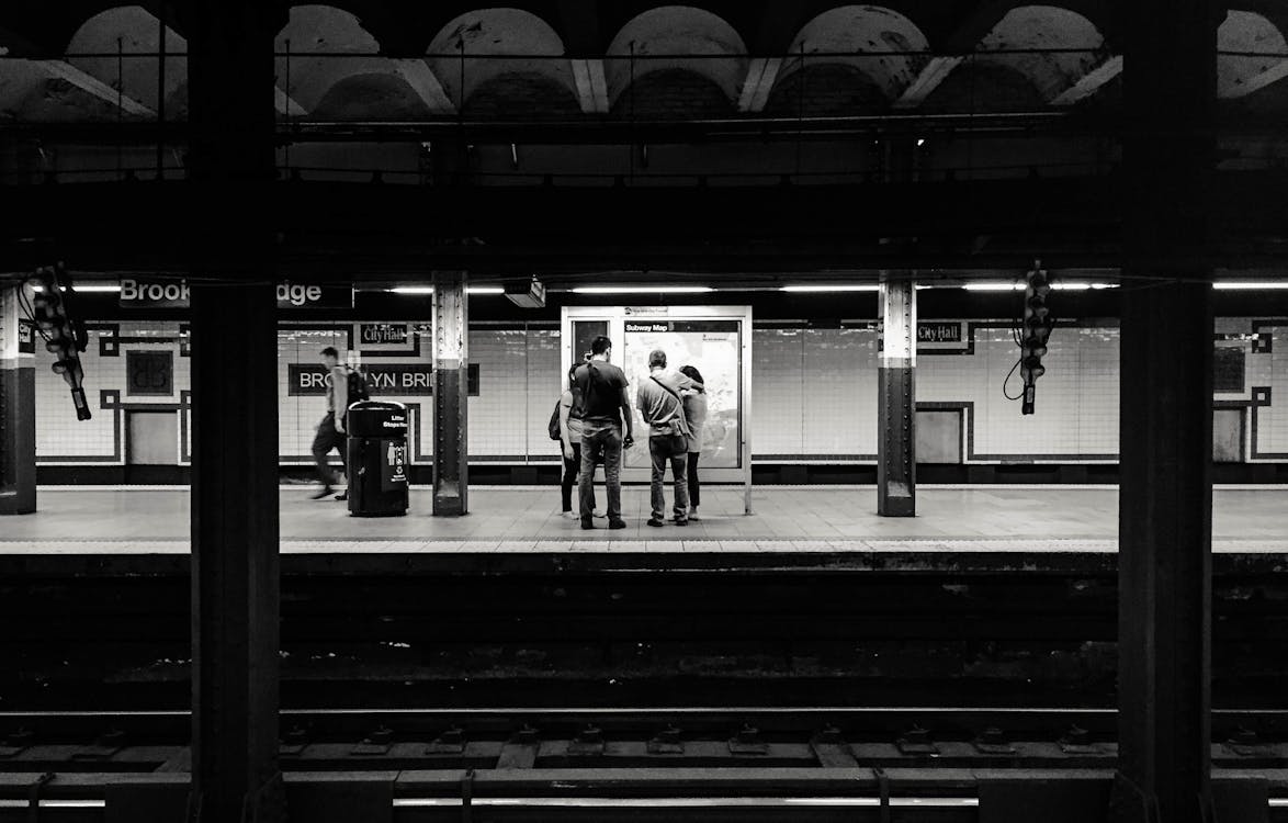 Free Black and white of anonymous people waiting for train on platform of subway station Stock Photo