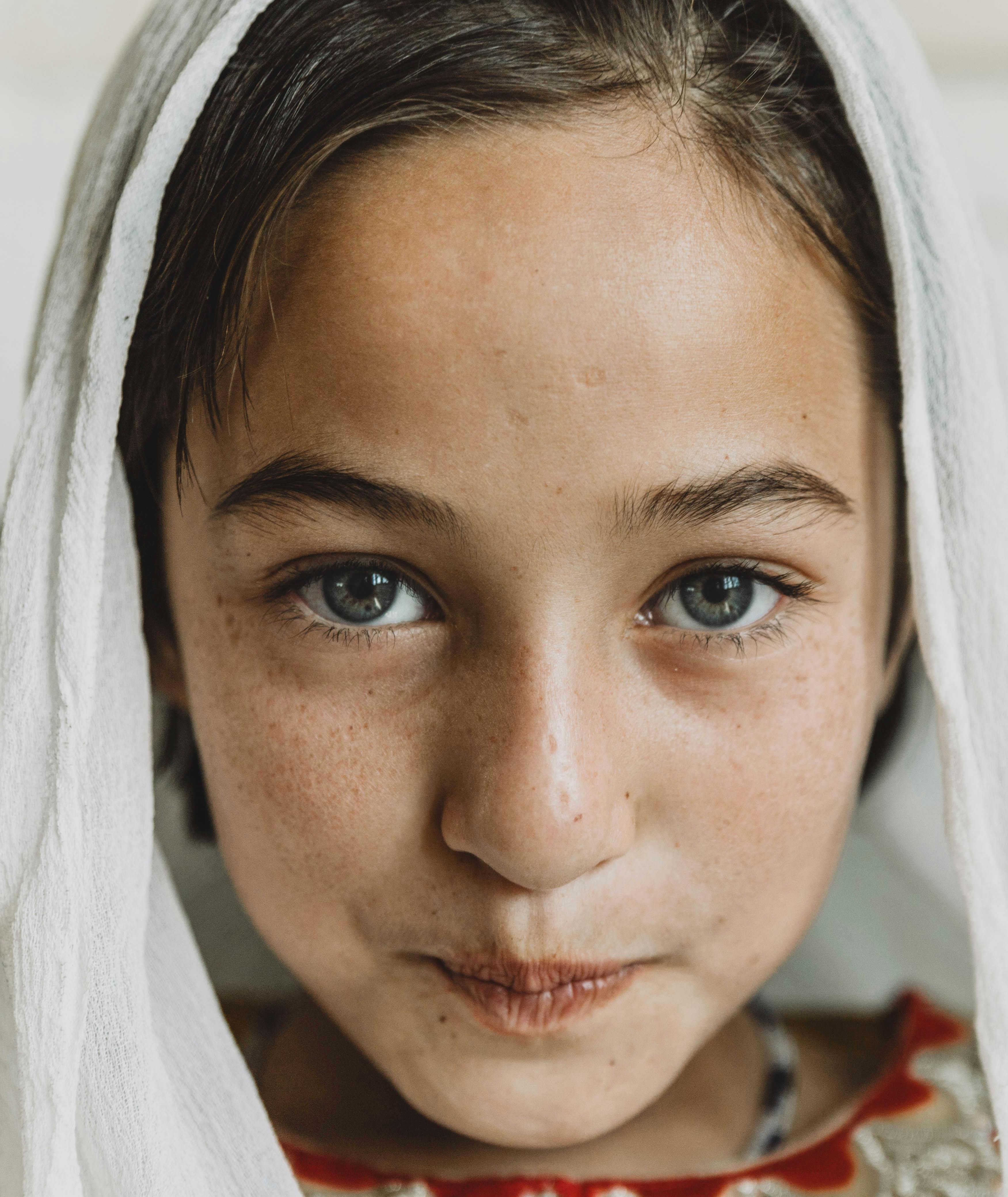 close up photo of girl wearing white headscarf