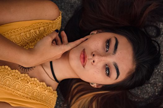 一位身着黄色礼服的女性肖像，展现了自然美景与雀斑