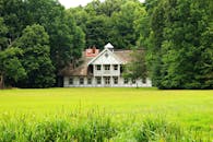 White and Brown Concrete House Near Grass Field